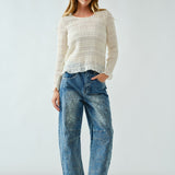 Front portrait of model wearing Floral Embroidered Barrel Leg Jeans in medium wash