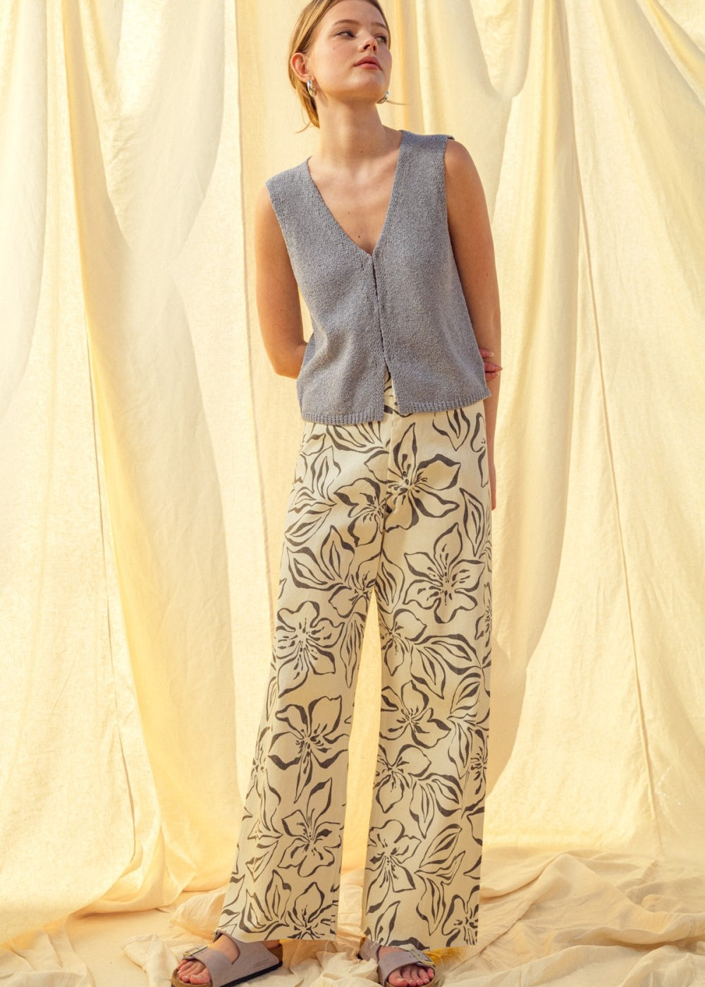 Woman wearing charcoal floral print wide leg denim pants styled with casual outfit