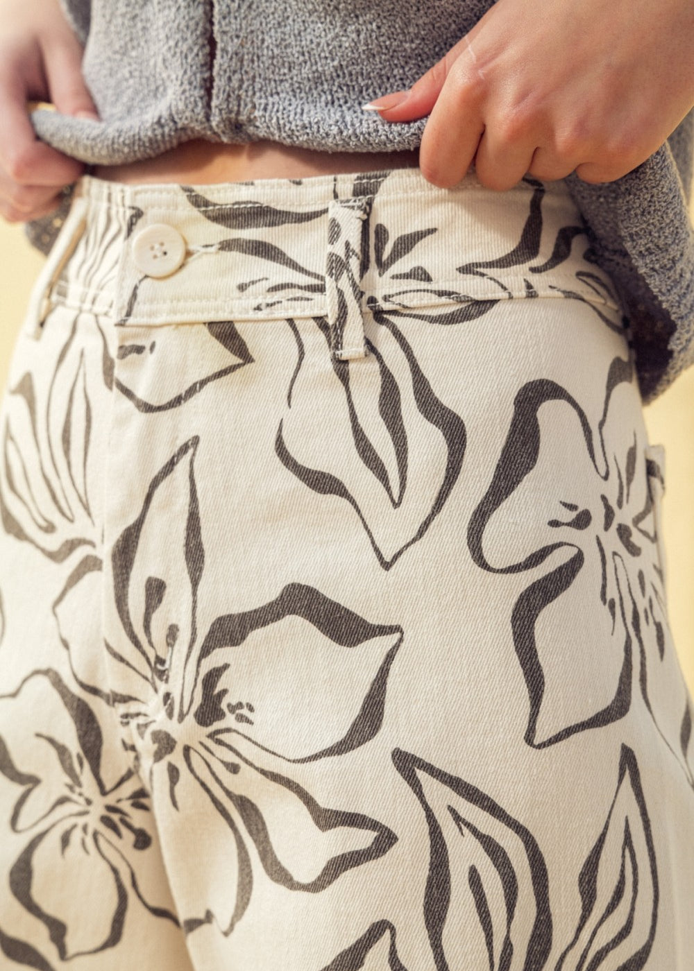 Close-up of charcoal floral print pattern on stretch wide leg denim pants