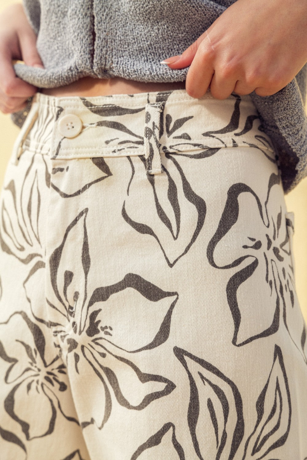 Close-up of charcoal floral print pattern on stretch wide leg denim pants