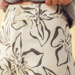 Close-up of charcoal floral print pattern on stretch wide leg denim pants