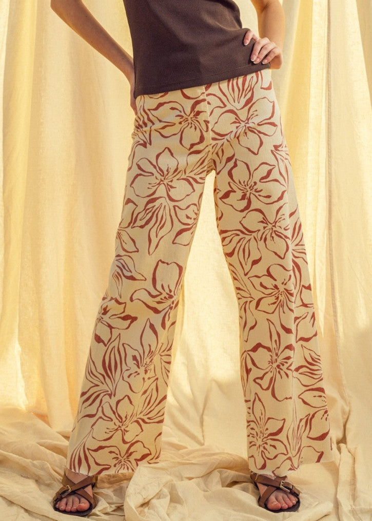 Woman wearing red floral print wide leg denim pants styled with casual outfit
