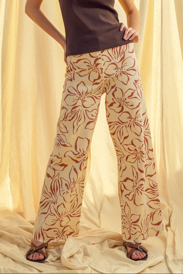 Woman wearing red floral print wide leg denim pants styled with casual outfit
