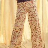 Woman wearing red floral print wide leg denim pants styled with casual outfit