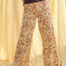Woman wearing red floral print wide leg denim pants styled with casual outfit