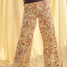 Woman wearing red floral print wide leg denim pants styled with casual outfit
