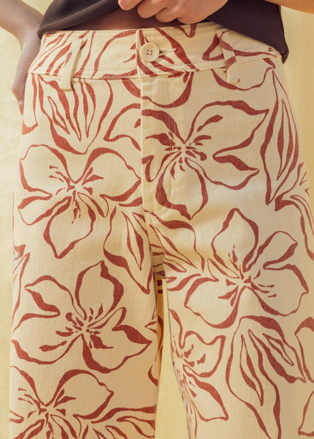 Close-up of red floral print pattern on wide leg stretch denim pants