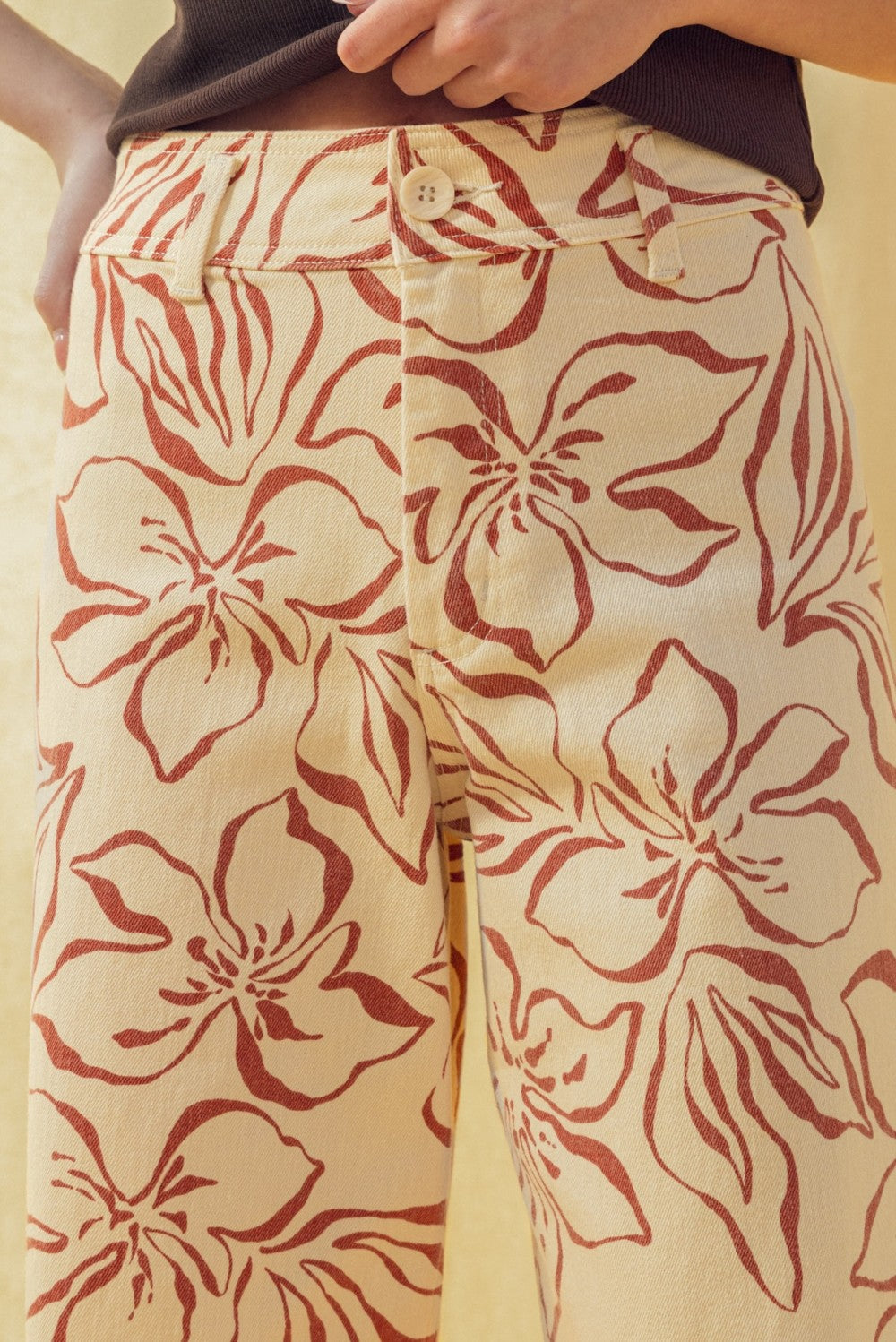 Close-up of red floral print pattern on wide leg stretch denim pants