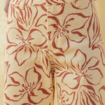 Close-up of red floral print pattern on wide leg stretch denim pants