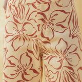 Close-up of red floral print pattern on wide leg stretch denim pants