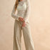 Woman wearing tan and olive floral wide leg corduroy pants styled with casual outfit
