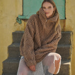 Woman wearing a taupe half-zip teddy fleece jacket outdoors