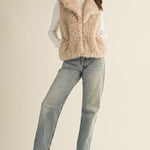 Full-body view of the faux fur vest styled casually with jeans