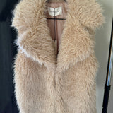 Close-up detail of the soft faux fur texture on the Fuzzy Dream Vest displayed on a hanger, with no model shown