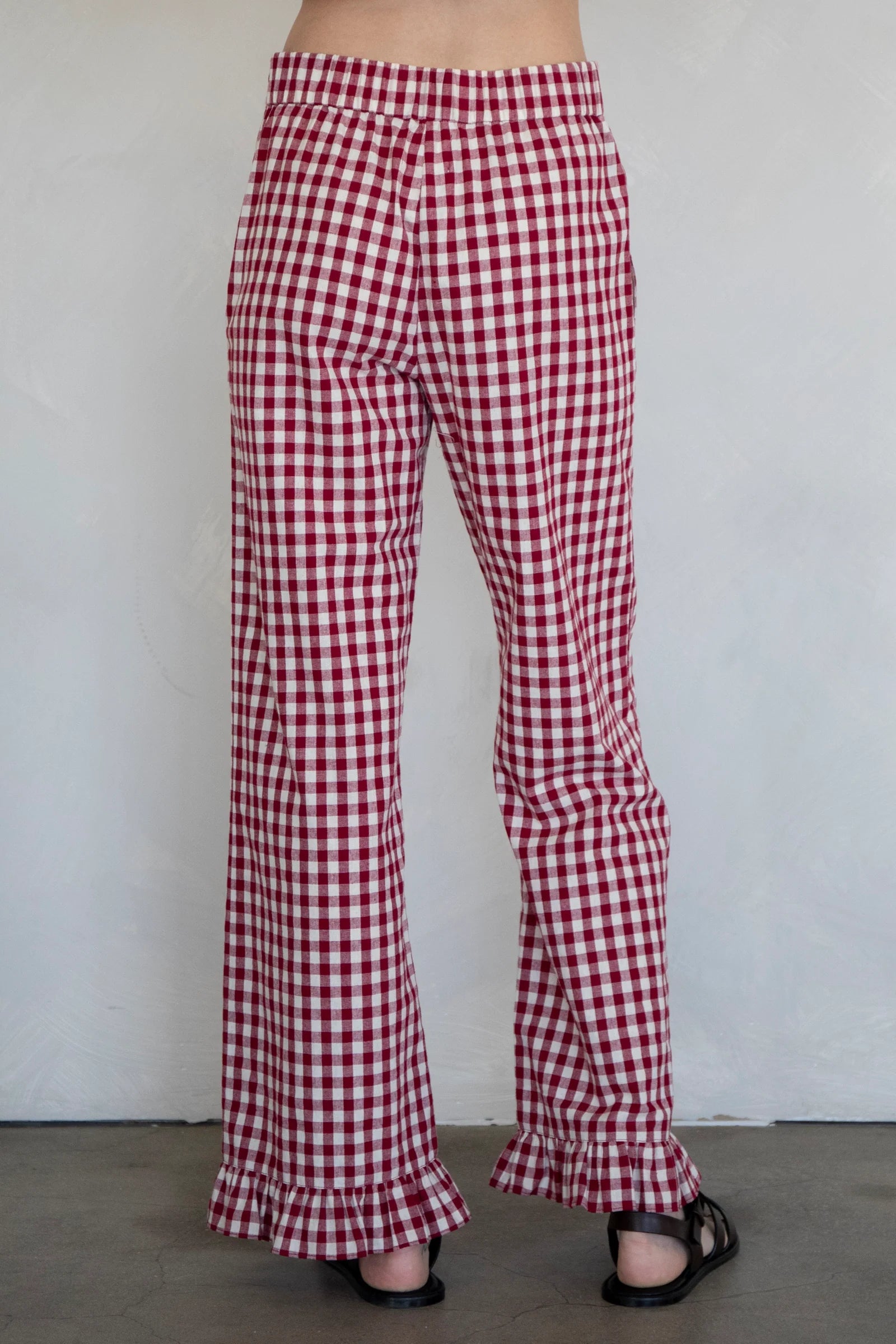 Back view of burgundy gingham cotton pants with relaxed silhouette