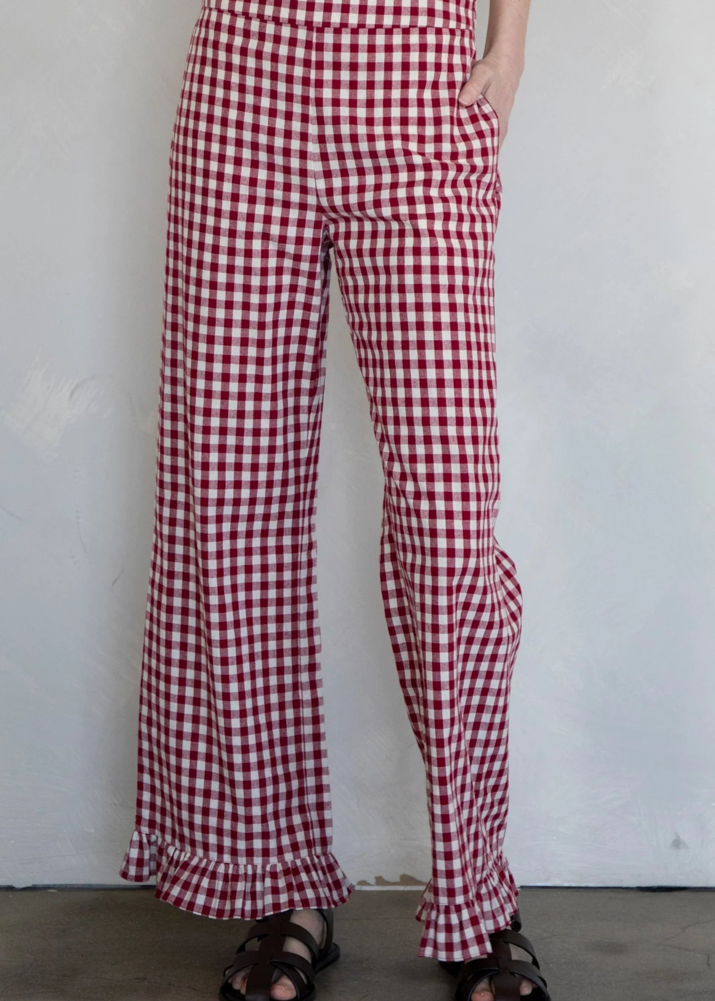 Front view of burgundy gingham cotton pants with elastic waistband
