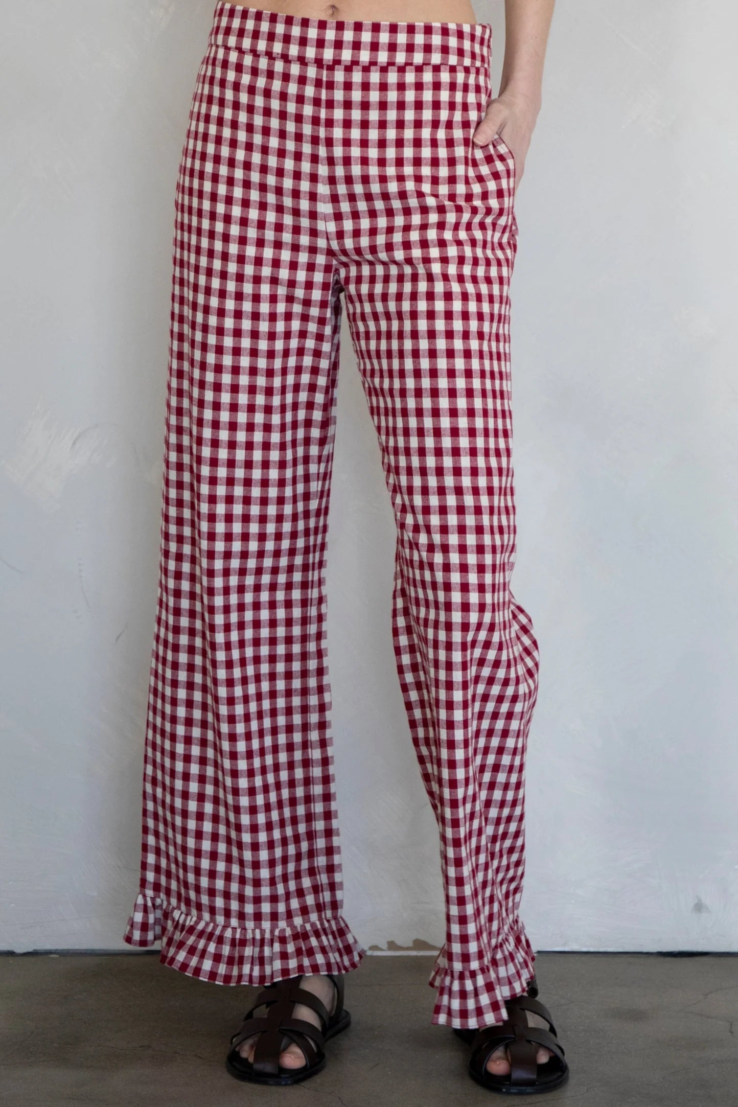 Front view of burgundy gingham cotton pants with elastic waistband