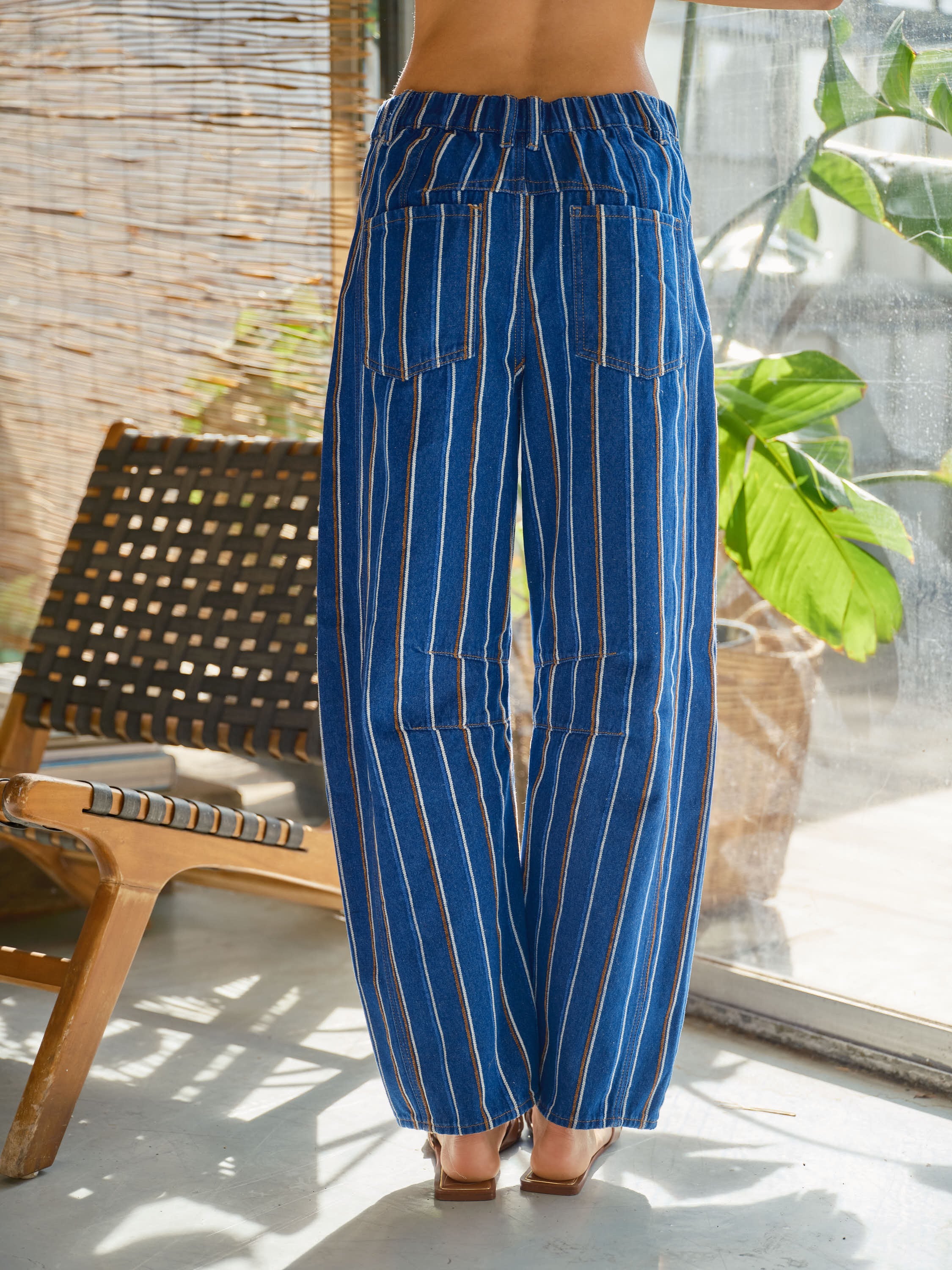 Back view of Good Luck Barrel Jeans in navy denim with white and brown vertical stripes and elastic back waistband.