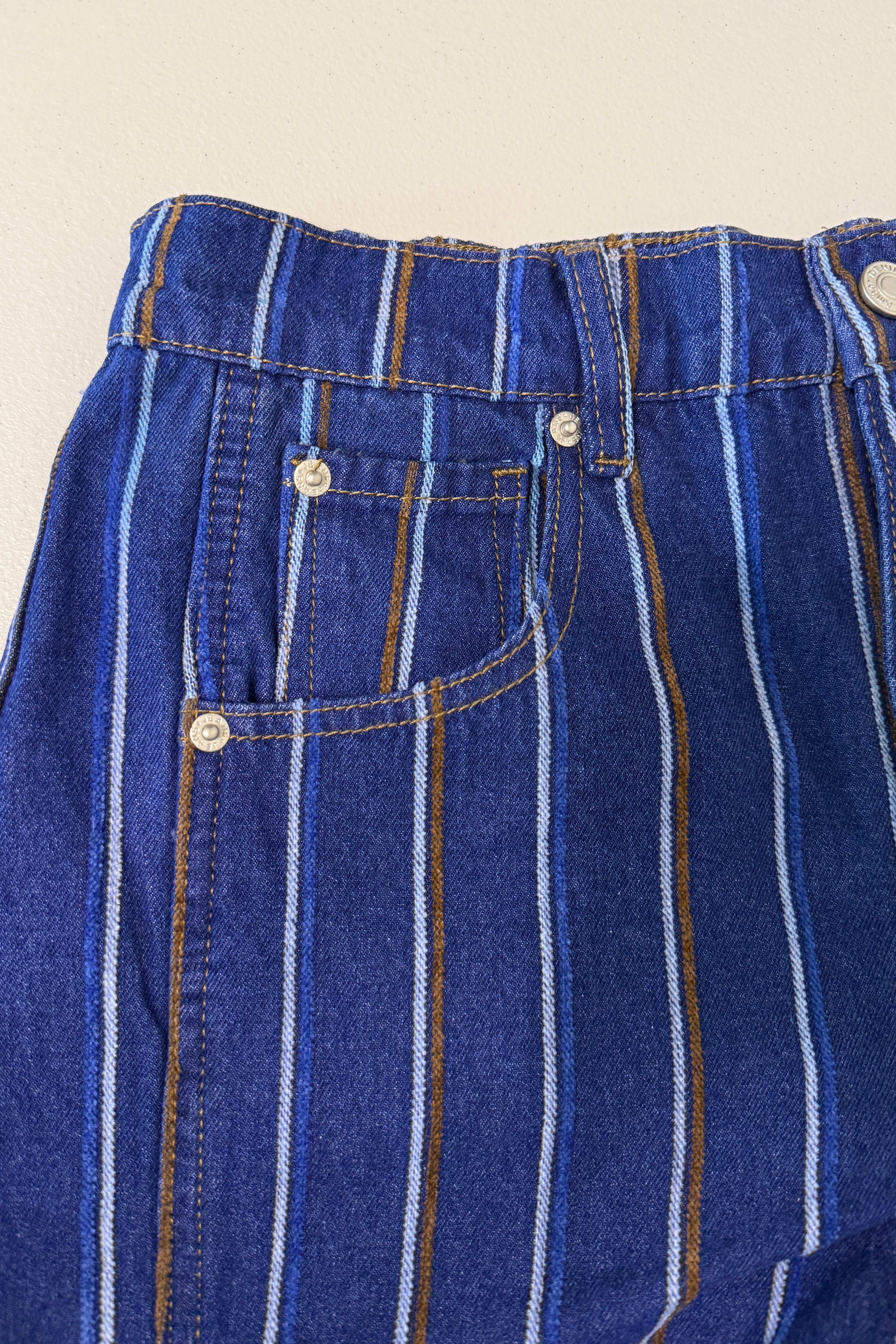 Close-up detail of Good Luck Barrel Jeans showing navy denim, brushed white and brown stripes, pockets, and button closure.