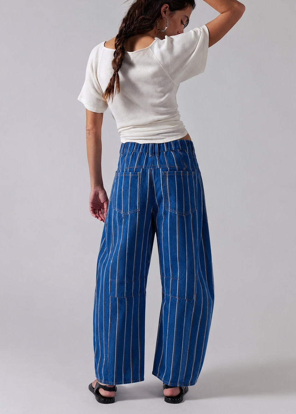 Studio back view of Good Luck Barrel Jeans showing the elastic back waistband, striped denim, and relaxed barrel silhouette.