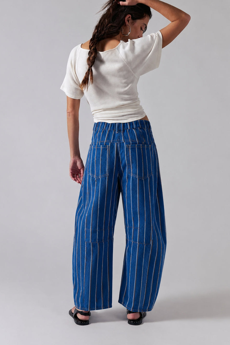 Studio back view of Good Luck Barrel Jeans showing the elastic back waistband, striped denim, and relaxed barrel silhouette.