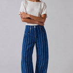 Studio front view of Good Luck Barrel Jeans in navy denim with white and brown vertical stripes and relaxed barrel-leg fit.