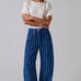 Studio front view of Good Luck Barrel Jeans in navy denim with white and brown vertical stripes and relaxed barrel-leg fit.