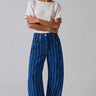 Studio front view of Good Luck Barrel Jeans in navy denim with white and brown vertical stripes and relaxed barrel-leg fit.
