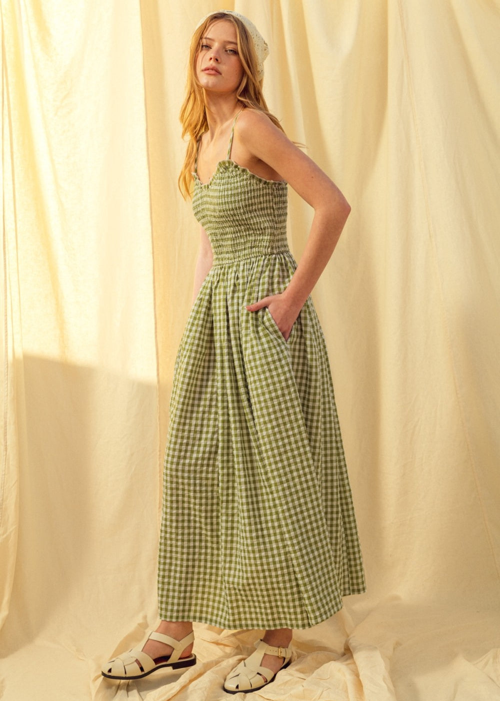 Side view of green gingham cotton maxi dress with smocked bodice