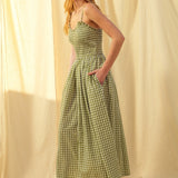 Side view of green gingham cotton maxi dress with smocked bodice