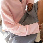 Close-up of soft knit fabric and buttons on Hailey cardigan in baby pink
