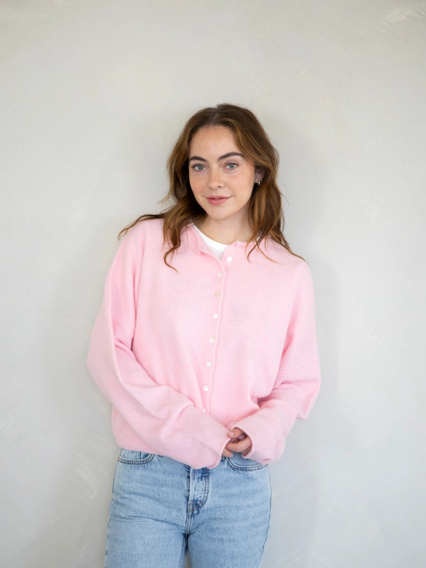 model is wearing Hailey button down cardigan in baby pink - Angled front view 