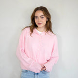model is wearing Hailey button down cardigan in baby pink - Angled front view 