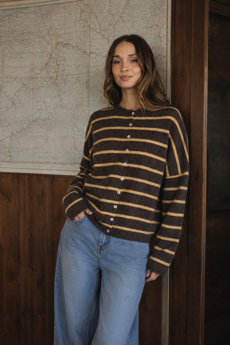 Model wearing the Hailey Button Down Cardigan in Cabana Stripe Brown-Orange, front lifestyle view