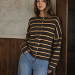 Model wearing the Hailey Button Down Cardigan in Cabana Stripe Brown-Orange, front lifestyle view