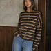 Model wearing the Things Between Piper Cardigan Cabana Stripe Brown Orange, front lifestyle view