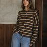 Model wearing the Things Between Piper Cardigan Cabana Stripe Brown Orange, front lifestyle view