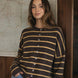 Model wearing the Hailey Button Down Cardigan in Cabana Stripe Brown-Orange, front lifestyle view