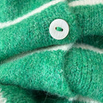 Close-up of Hailey button down cardigan in Kelly green cabana stripe with button detail