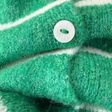 Close-up of Hailey button down cardigan in Kelly green cabana stripe with button detail