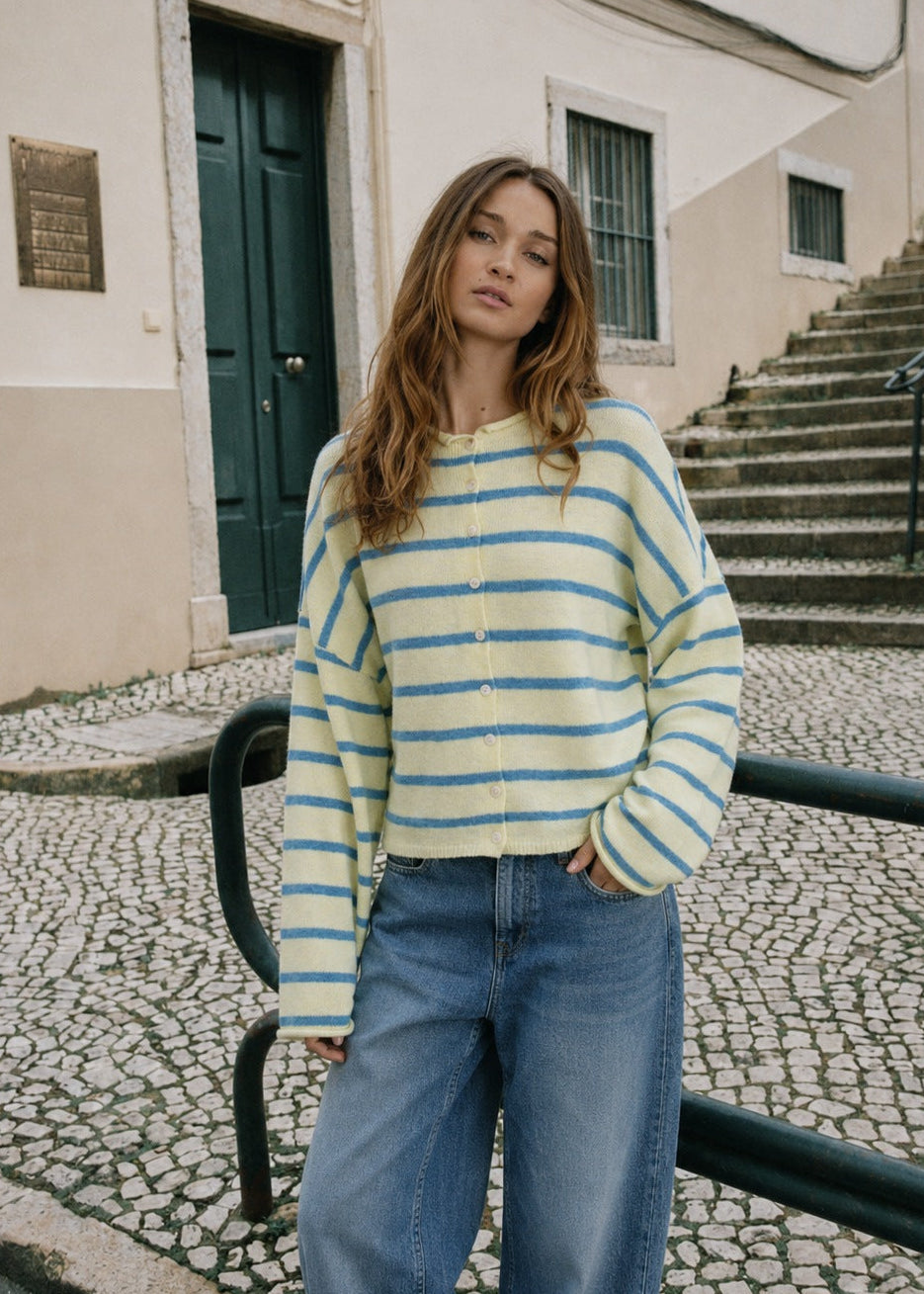 Model wearing the Things Between Piper Cardigan Cabana Stripe Light Yellow, front lifestyle view
