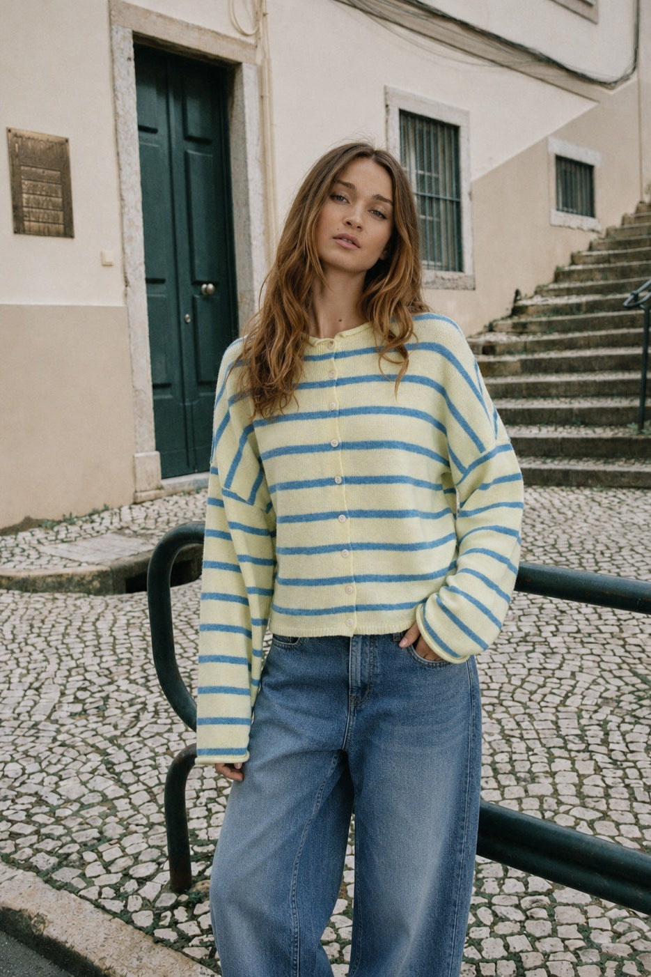 Model wearing the Hailey Button Down Cardigan in Cabana Stripe Light Yellow, front lifestyle view