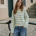 Model wearing the Hailey Button Down Cardigan in Cabana Stripe Light Yellow, front lifestyle view
