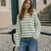 Model wearing the Things Between Piper Cardigan Cabana Stripe Light Yellow, front lifestyle view