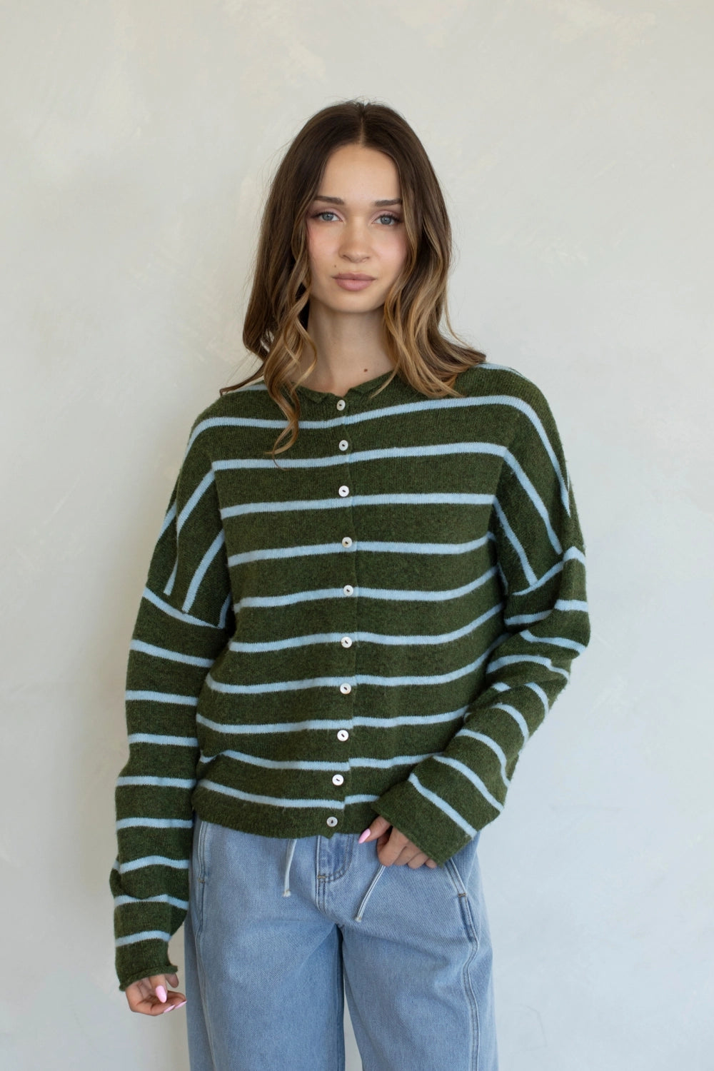 Front view of the Hailey Button Down Cardigan in Cabana Stripe Olive-Blue with button-down front and light blue stripes