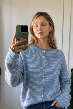 Lifestyle selfie of a model wearing the Hailey Dusty Blue pin-striped cardigan.