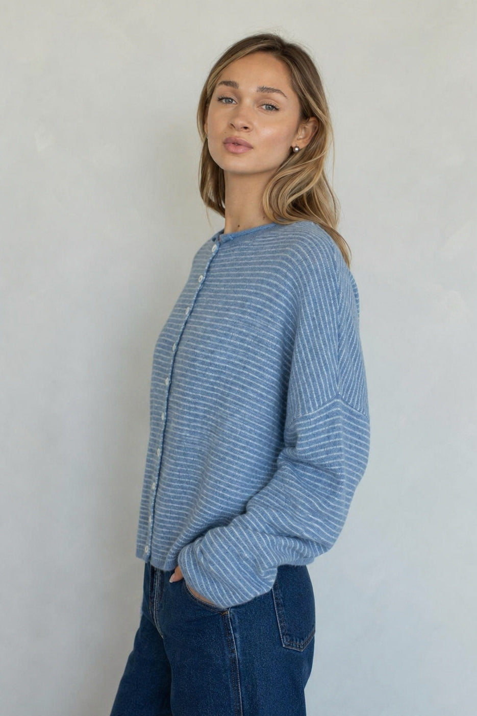 Side view of the Hailey Dusty Blue pin-striped cardigan showing its relaxed fit.
