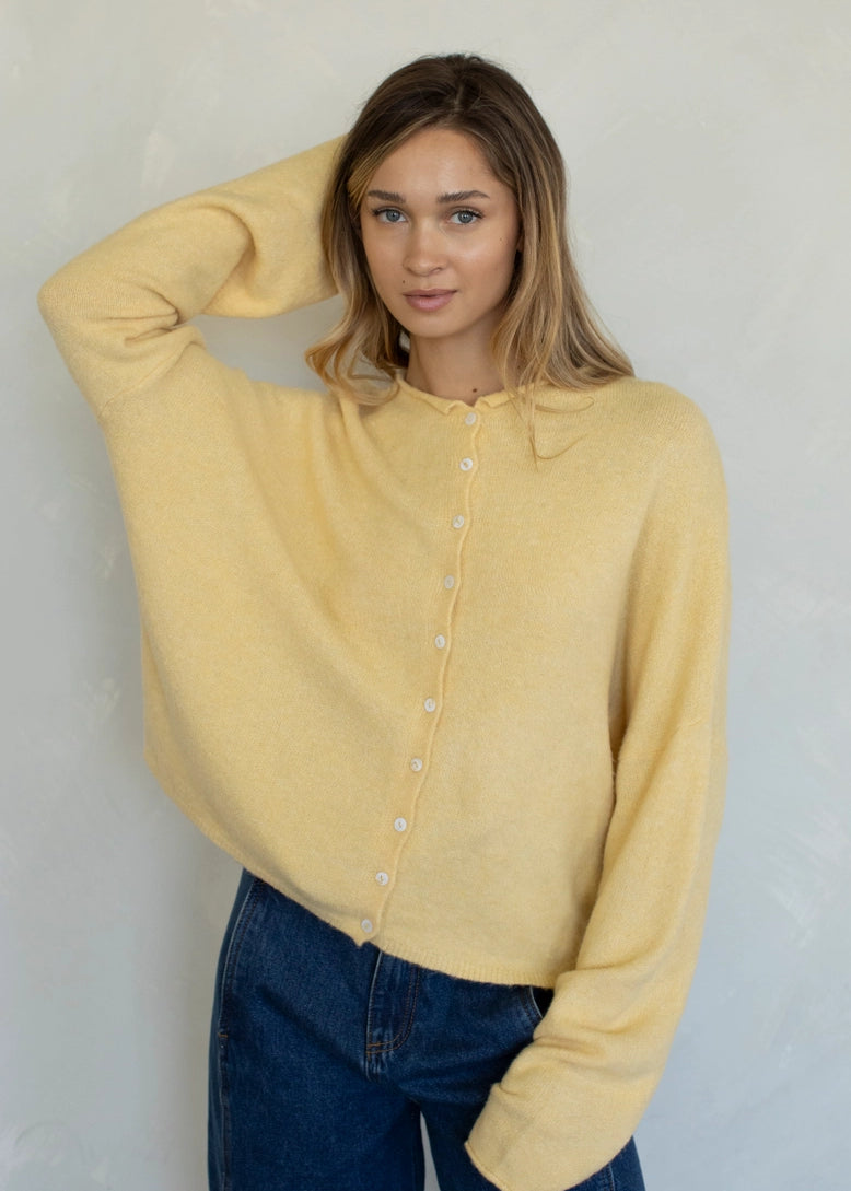 Front portrait of model wearing the Hailey Button Down Cardigan (Piper Cardigan) in honey