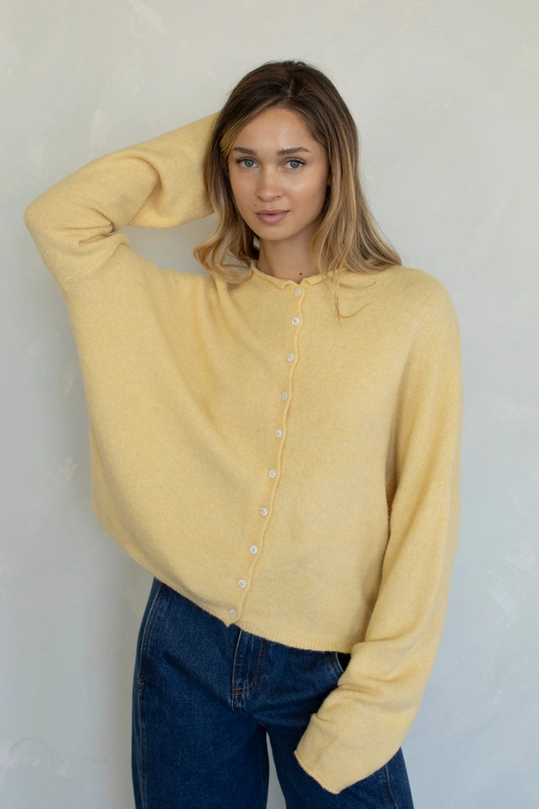 Front portrait of model wearing the Hailey Button Down Cardigan (Piper Cardigan) in honey