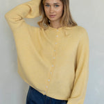 Front portrait of model wearing the Hailey Button Down Cardigan (Piper Cardigan) in honey